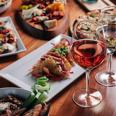 Various dishes displayed with wine, close up.