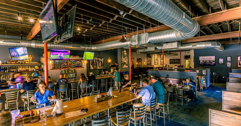 Interior, guests sitting at tables and bar counter