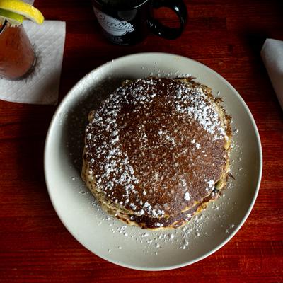 Pancakes topped with powdered sugar.