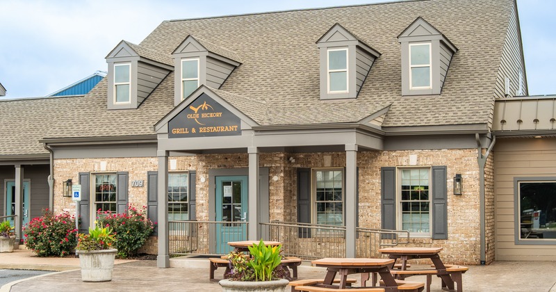 Exterior, wide view to restaurant, benches and tables in front