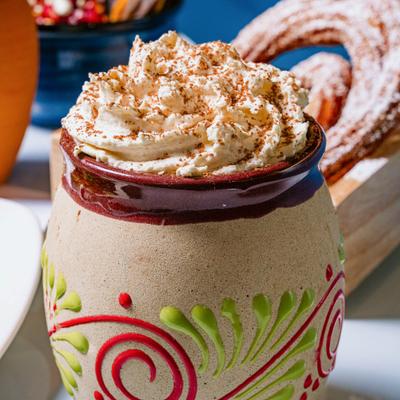 Mexican hot chocolate drink served in a traditional clay mug.