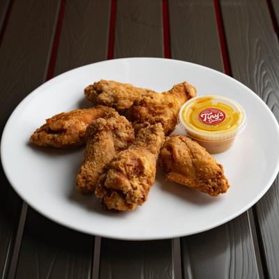Fried Chicken Wings served with a cup of dipping sauce.
