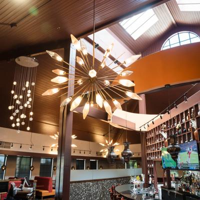 Bar area, modern lighting,  wood-paneled ceiling with skylights.