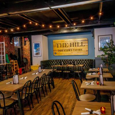 Dining area, a cozy atmosphere with both booth and table seating.