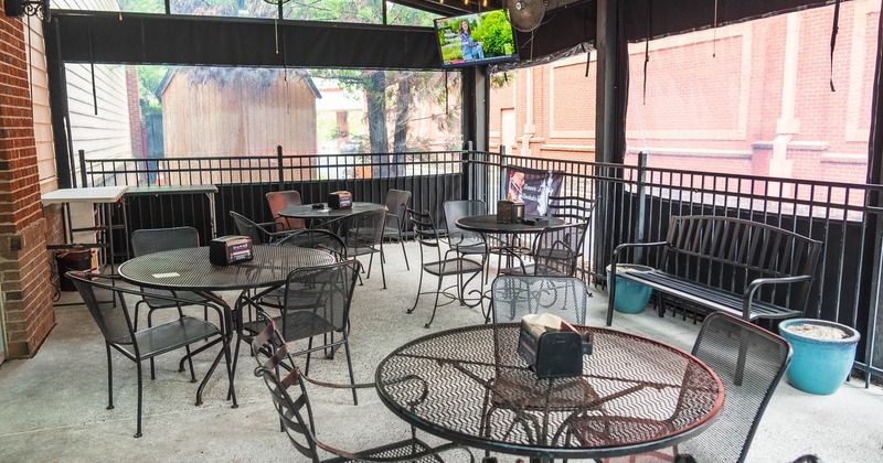 Covered part of the patio with seating and tables