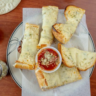 Garlic cheese bread served with marinara sauce on the side, top view.