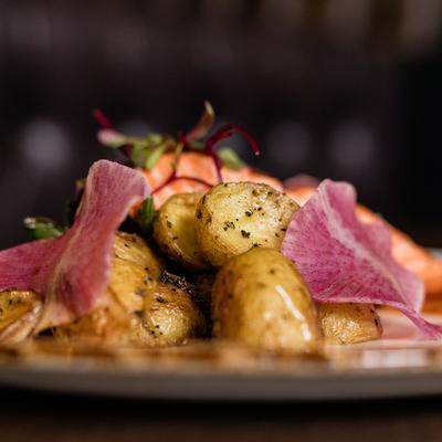 Seasoned roasted potatoes garnished with daikon slices.