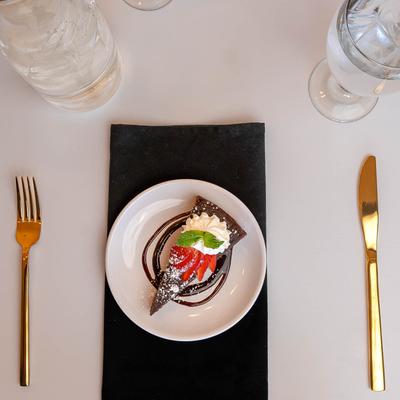 Flourless Chocolate Torte topped with strawberries and whipped cream.