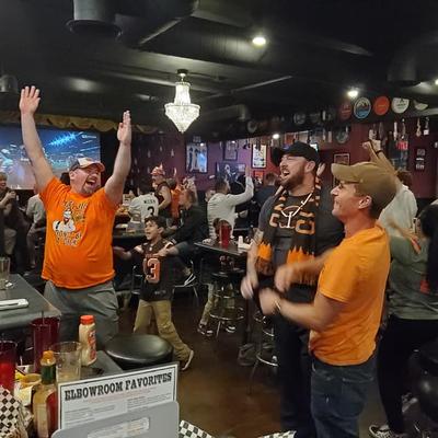 Fans with raised hands cheering