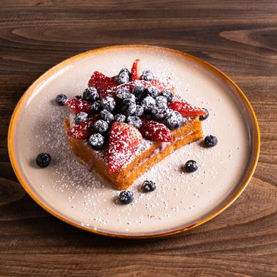 French toast topped with berries and powdered sugar.