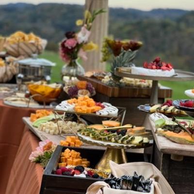 Catering food on tables outside.
