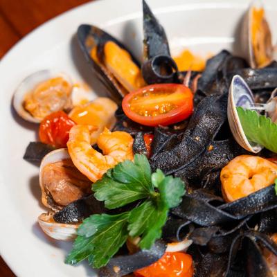 Seafood squid ink pasta in marinara sauce.