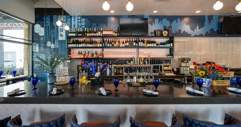 Modern and spacious restaurant interior, bar counter set for guests