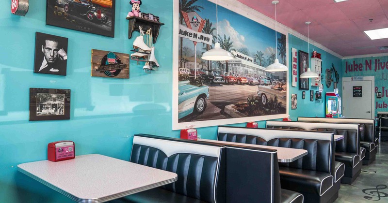 Interior with turquoise walls, vintage decor, and classic dining booths.