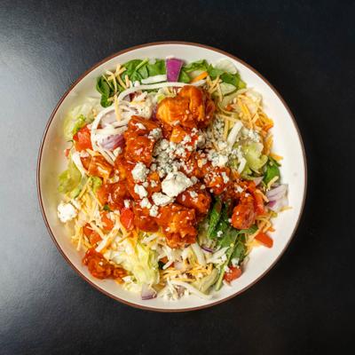 Buffalo Chicken Salad with fresh vegetables, shredded cheddar, and blue cheese crumbles.