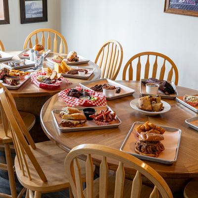 Interior, assorted food plates spread on two tables.