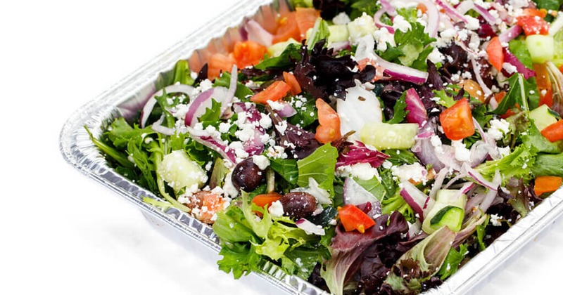 Greek salad in a foil container