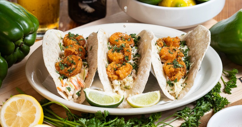 Shrimp tacos served with lime wedges