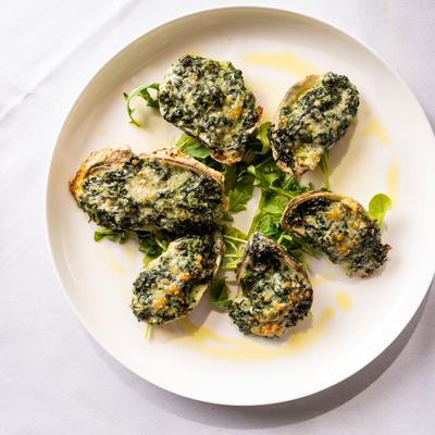 Oysters Rockefeller, with butter and green herbs.