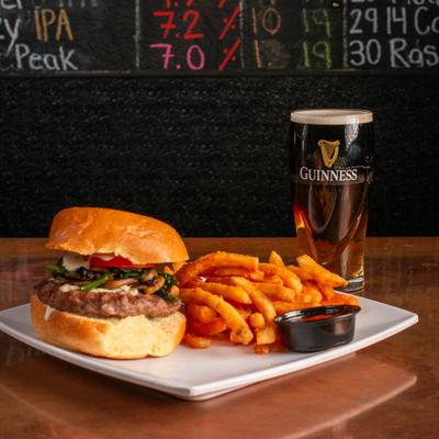Cafe Aged Bleu Cheese Burger served with fries and a beer.