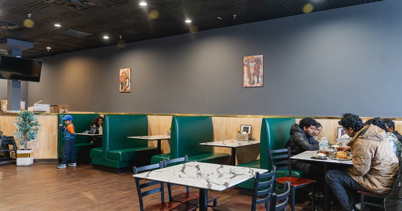 Interior dining space with leather booths and marble tables