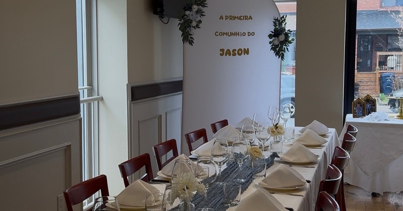 Interior featuring a dining table set with white tablecloths, napkins, and a blue table runner