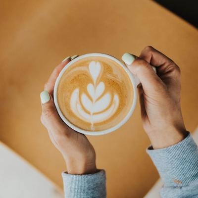 Hands holding a coffee cup.