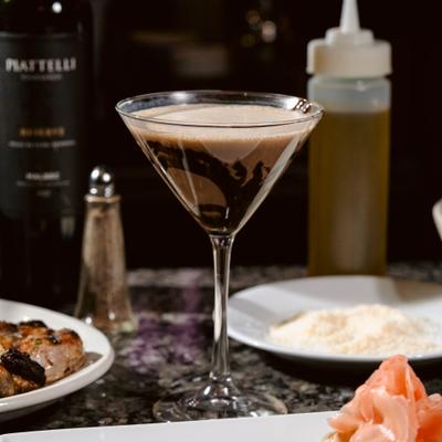 Esspresso Martini cocktail served alongside food.