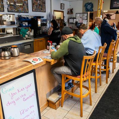 Restaurant customers sitting at the bar.