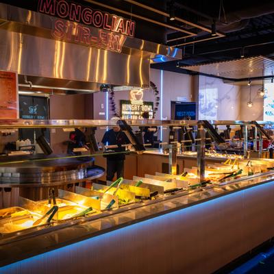 Interior featuring buffet serving station with stainless steel food warmers and signage.