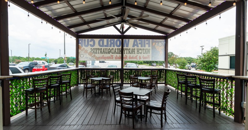 Exterior, patio, covered seating area, restaurant front, tables with chairs, wooden decking