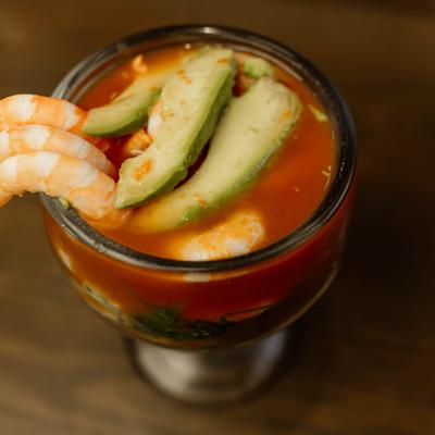 Shrimp cocktail with avocado slices, close-up.
