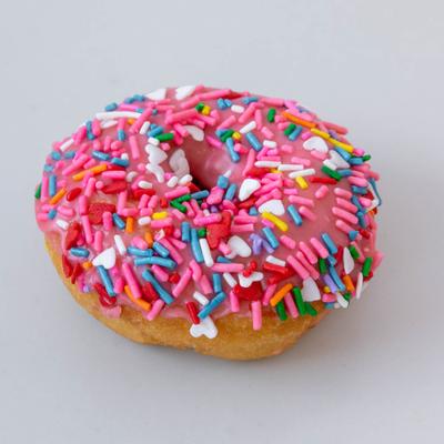 Cake donut with pink frosting and sprinkles.