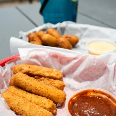Mozzarella sticks served with marinara sauce.