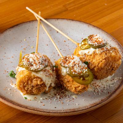 Fried Corn with a cheese sauce and jalapeno