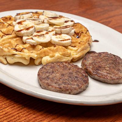 Sausage patties, and waffle with bananas.