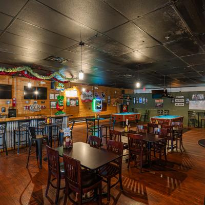 Interior, dining venue, tables, chairs, dining bar, pool tables behind.