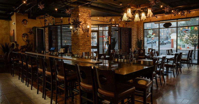 Interior, seating area, long community table setup for eighteen, regular tables for four