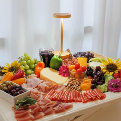 Charcuterie with cold cuts, fruit, and cheeses.