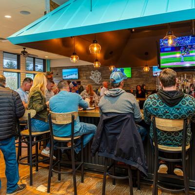 People at the bar enjoying drinks.