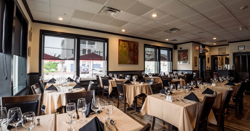 Interior, dining tables and chairs ready for guests