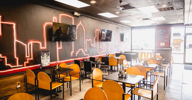 Interior, dining area, tables for four, entrance, large shop window, TVs on the wall