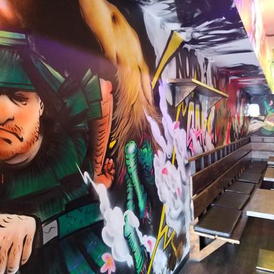 Interior, colorful mural in a seating area.