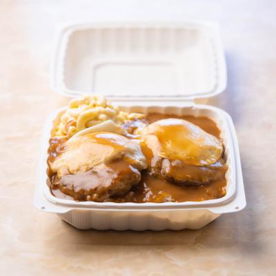 Beef patties with gravy and mac salad.