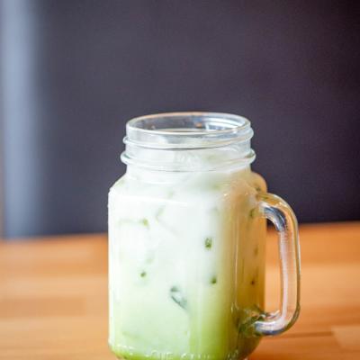 Matcha Milk Tea served in a glass mug.