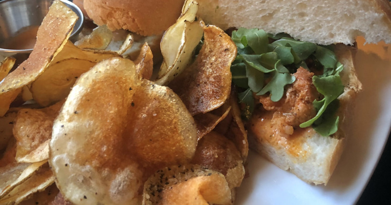 Alligator Po' Boy, blackened alligator on French bread, served with chips