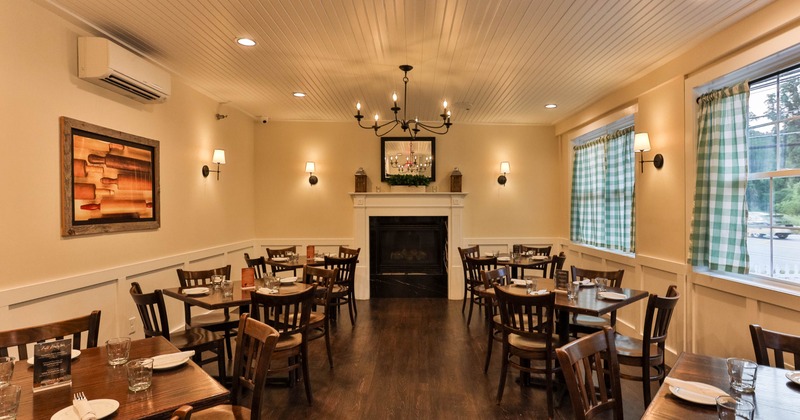 Cozy restaurant dining area with tables, chairs, a fireplace