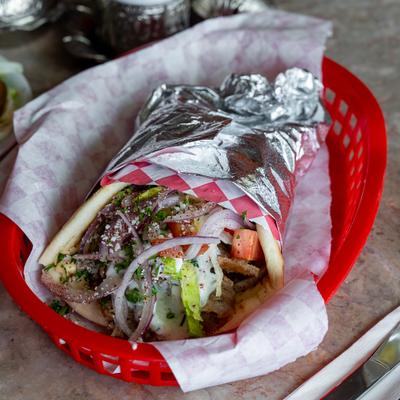 Gyro wrap with lettuce, onion, tomato and herbs.