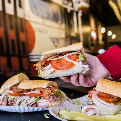 Customer holding a sandwich.