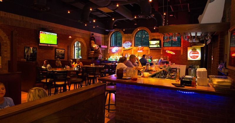 Bar area with tall tables and bar stools